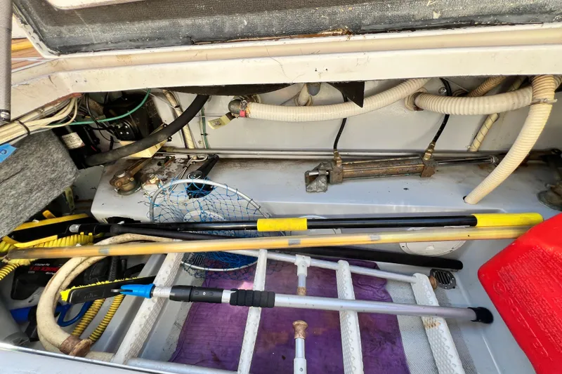 Slide: The Image of Engine compartment of a 1990 Mediterranean 38 Sport Fisher with fishing gear and equipment. - 69