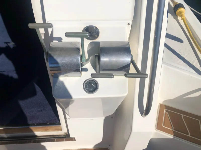 Slide: The Image of Control panel of a 1990 Mediterranean 38 Sport Fisher boat with throttle levers. - 9