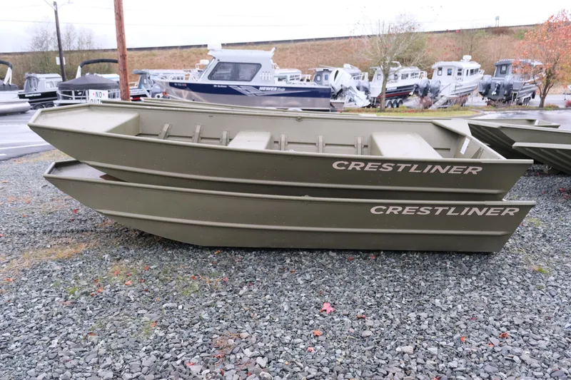 Slide: The Image of 2024 Crestliner 1448M CR Jon boats stacked on gravel lot. - 3
