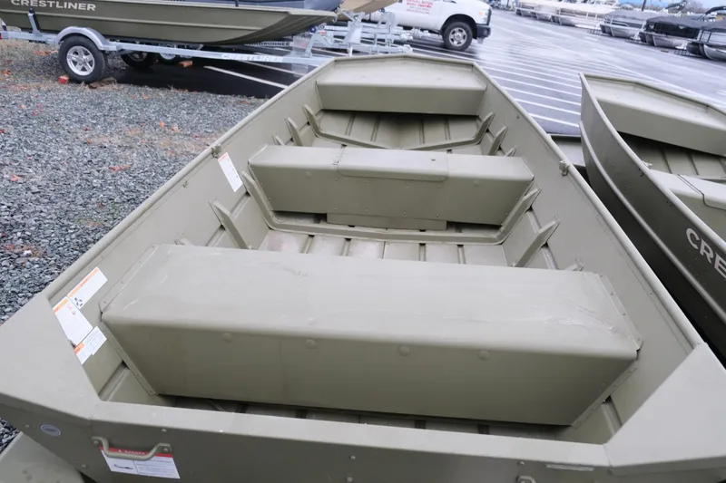 Slide: The Image of 2024 Crestliner 1448M CR Jon boat, olive green, parked on gravel lot. - 4