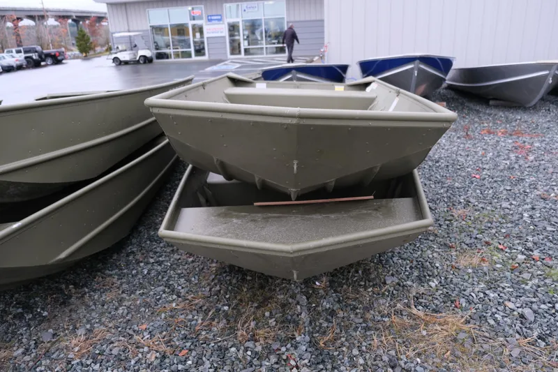 Slide: The Image of 2024 Crestliner 1448M CR Jon boats stacked outside dealership. - 6