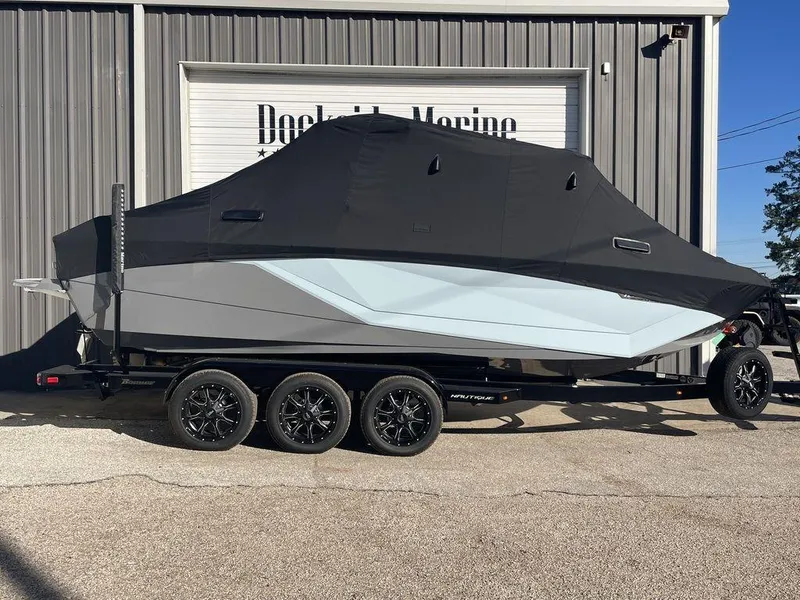 Slide: The Image of 2024 Nautique Super Air Nautique G23 boat covered on a trailer outside Dockside Marine. - 10