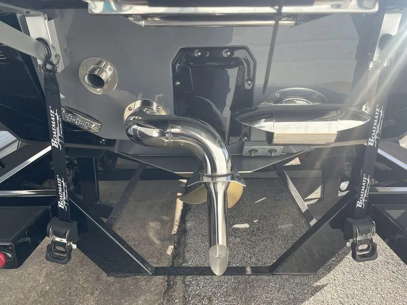 Slide: The Image of 2024 Nautique Super Air Nautique G23 boat rear view with exhaust and trailer. - 2