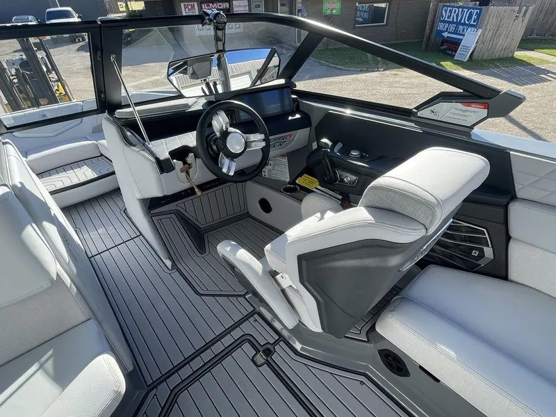Slide: The Image of 2024 Nautique Super Air Nautique G23 boat interior with modern helm and seating. - 8