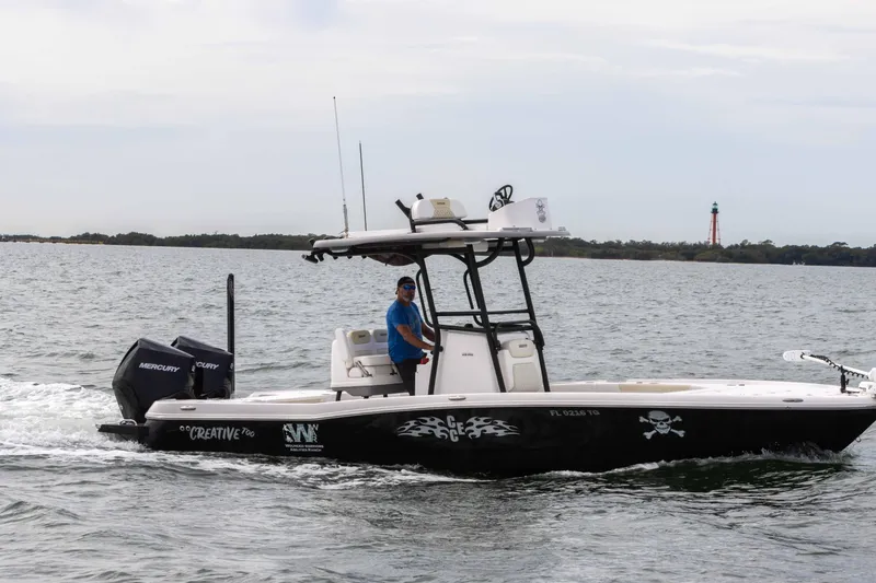 Slide: The Image of 2022 Caymas 281HB Center Console boat cruising on the water. - 1