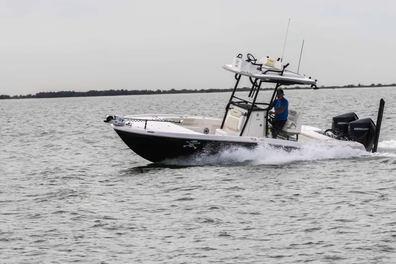 Slide: The Image of 2022 Caymas 281HB Center Console boat cruising on open water. - 10