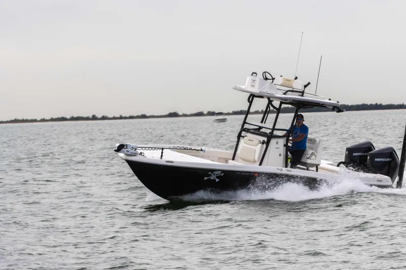 Slide: The Image of 2022 Caymas 281HB Center Console boat cruising on open water. - 11