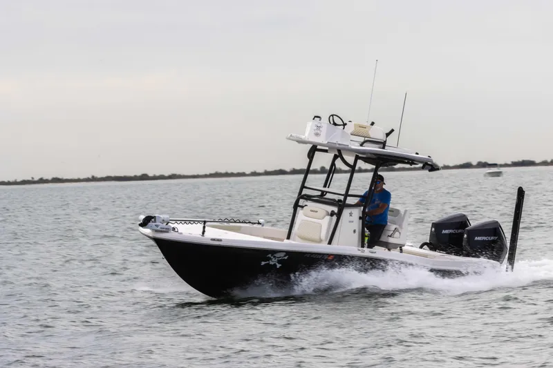 Slide: The Image of 2022 Caymas 281HB Center Console boat cruising on the water. - 12