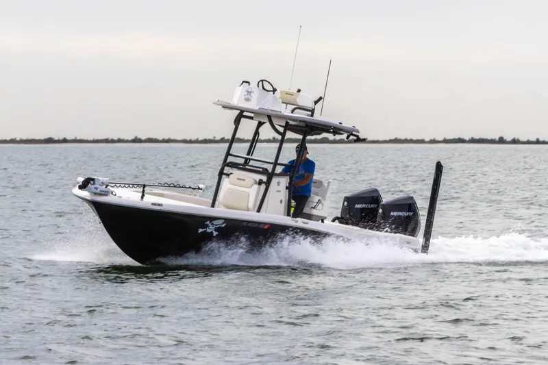 Slide: The Image of 2022 Caymas 281HB Center Console boat cruising on water. - 13