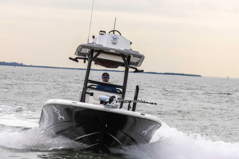 Slide: The Image of 2022 Caymas 281HB Center Console boat cruising on open water. - 16