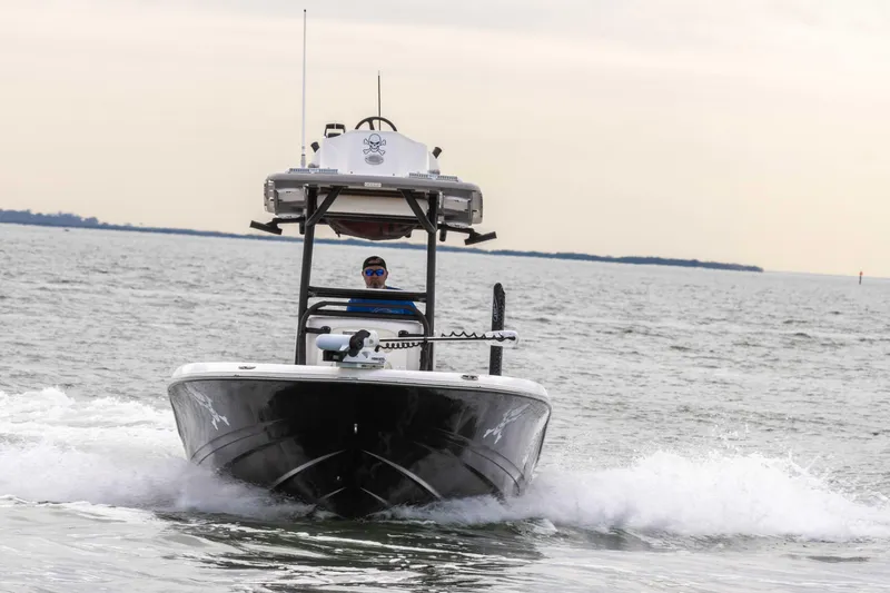 Slide: The Image of 2022 Caymas 281HB Center Console boat cruising on open water. - 17