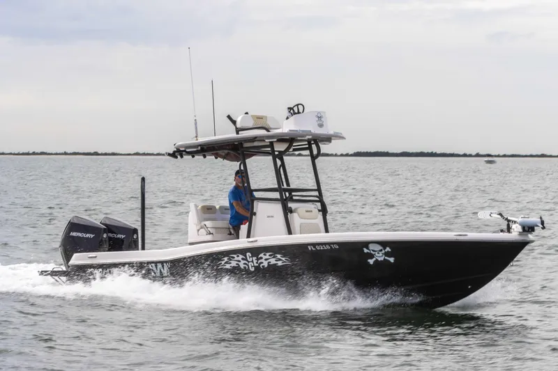 Slide: The Image of 2022 Caymas 281HB Center Console boat cruising on the water. - 2