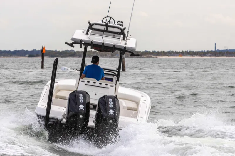 Slide: The Image of 2022 Caymas 281HB Center Console boat cruising on water. - 23