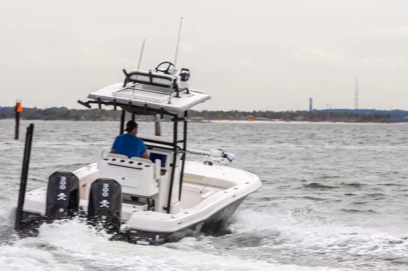 Slide: The Image of 2022 Caymas 281HB Center Console boat cruising on open water. - 26