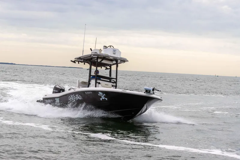 Slide: The Image of 2022 Caymas 281HB Center Console boat cruising on open water. - 27