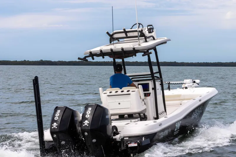 Slide: The Image of 2022 Caymas 281HB Center Console boat cruising on open water. - 3