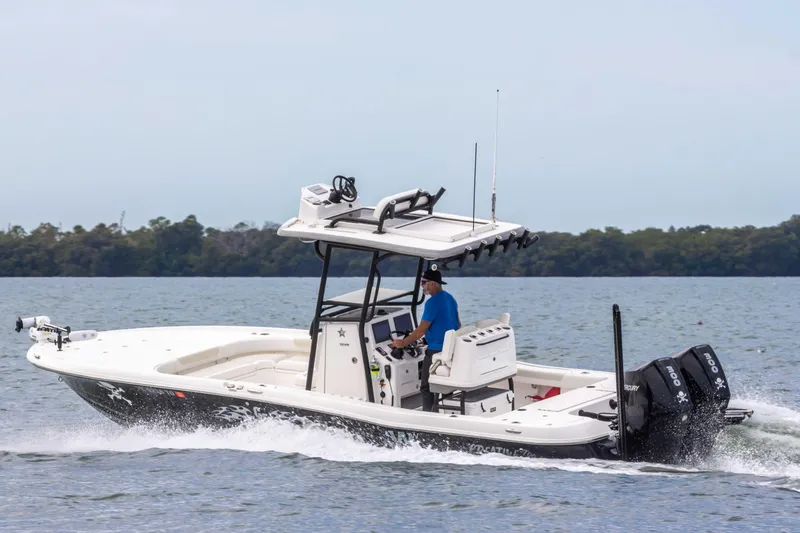 Slide: The Image of 2022 Caymas 281HB Center Console boat cruising on water. - 32