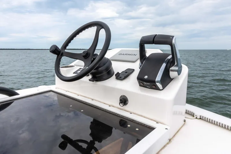 Slide: The Image of 2022 Caymas 281HB Center Console boat helm with steering wheel and controls. - 33