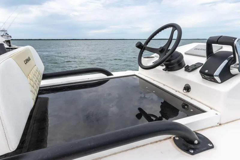 Slide: The Image of 2022 Caymas 281HB Center Console boat helm with steering wheel and throttle controls. - 35