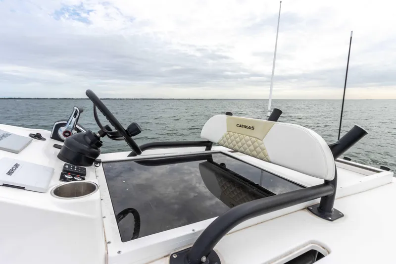 Slide: The Image of 2022 Caymas 281HB Center Console boat on open water. - 36