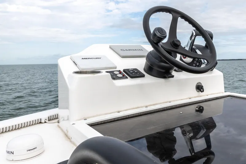 Slide: The Image of 2022 Caymas 281HB Center Console boat helm with Garmin and Mercury controls. - 37