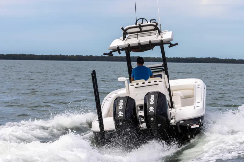 Slide: The Image of 2022 Caymas 281HB Center Console boat cruising on open water. - 4