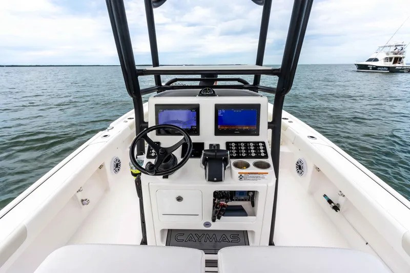 Slide: The Image of 2022 Caymas 281HB Center Console boat dashboard on open water. - 42