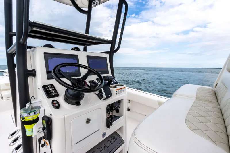 Slide: The Image of 2022 Caymas 281HB Center Console boat dashboard with dual screens and ocean view. - 44