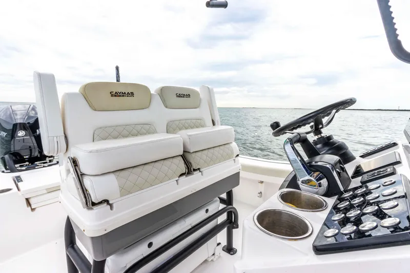 Slide: The Image of 2022 Caymas 281HB Center Console boat interior with dual seats and steering console. - 45