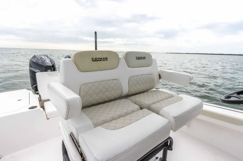 Slide: The Image of 2022 Caymas 281HB Center Console boat with cushioned seating on open water. - 47