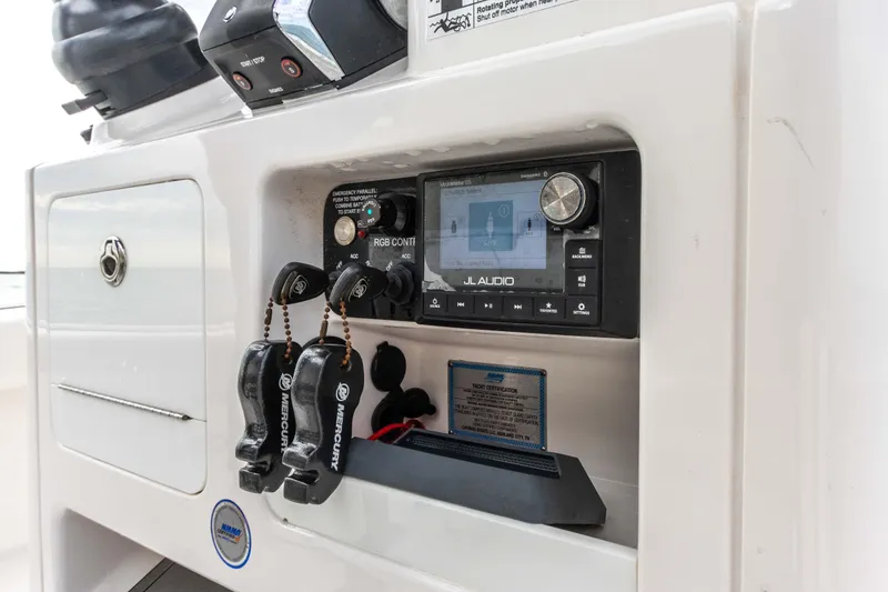 Slide: The Image of 2022 Caymas 281HB Center Console dashboard with JL Audio system and controls. - 49