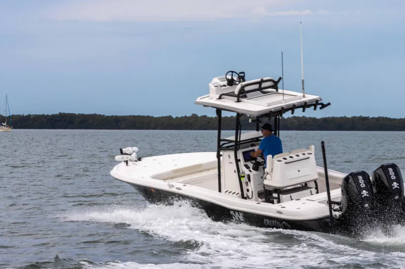 Slide: The Image of 2022 Caymas 281HB Center Console boat cruising on open water. - 6