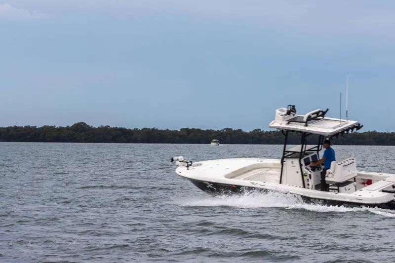 Slide: The Image of 2022 Caymas 281HB Center Console boat cruising on open water. - 8