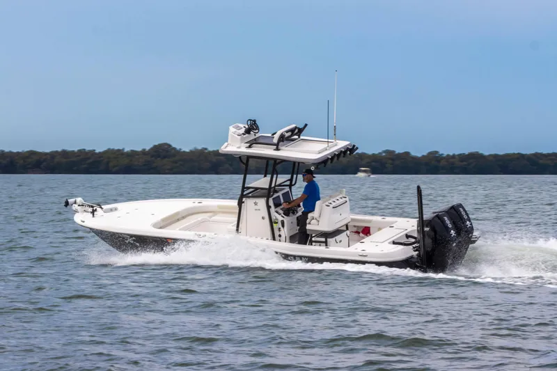 Slide: The Image of 2022 Caymas 281HB Center Console boat cruising on open water. - 9