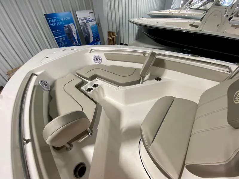 Slide: The Image of 2024 Key West 203 FS boat interior with beige seating and cup holders. - 17