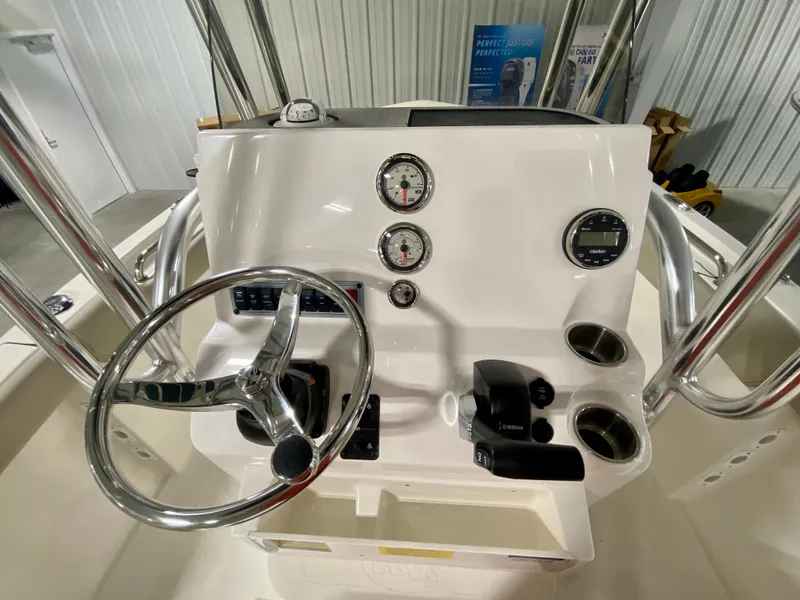 Slide: The Image of 2024 Key West 203 FS boat dashboard with steering wheel and gauges. - 9