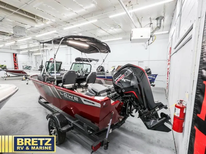 Slide: The Image of 2024 Fishing Machine 1775 WT boat in showroom, featuring powerful outboard motor. - 10
