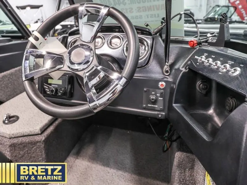 Slide: The Image of 2024 Fishing Machine 1775 WT boat dashboard with modern steering wheel and controls. - 15
