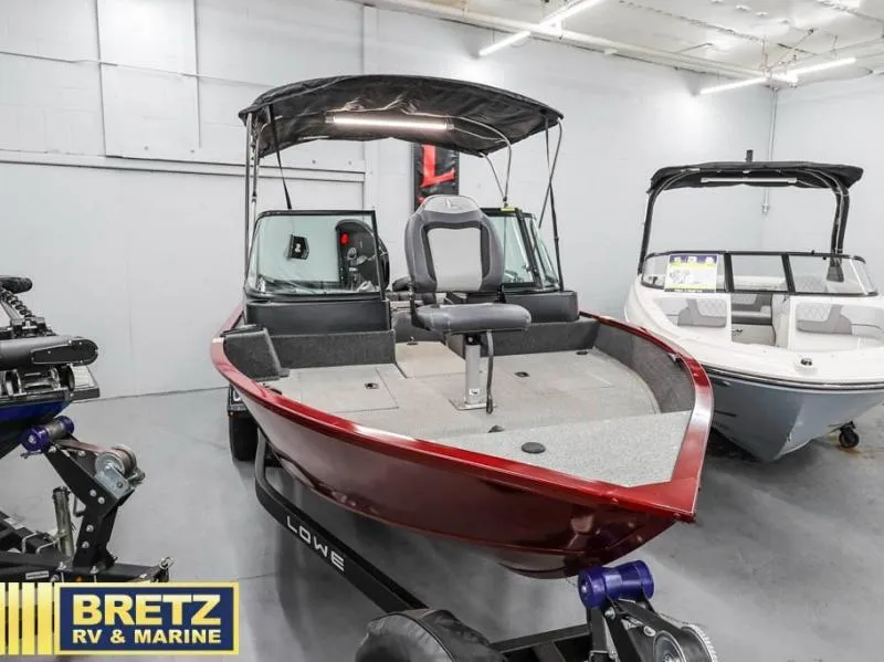 Slide: The Image of 2024 Fishing Machine 1775 WT boat in showroom, red exterior, displayed at Bretz RV & Marine. - 3