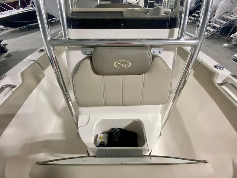 Slide: The Image of 2024 Key West 203 FS boat interior with storage compartment and cushioned seating. - 15