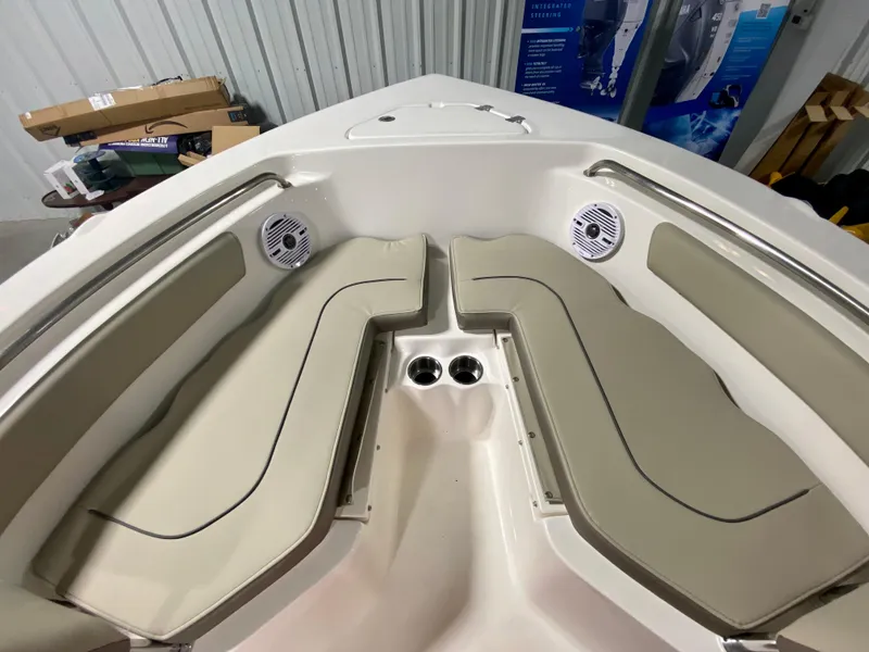 Slide: The Image of 2024 Key West 203 FS boat interior with beige seating and cup holders. - 16