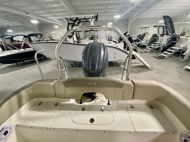 Slide: The Image of 2024 Key West 203 FS boat in showroom, rear view with outboard motor. - 6