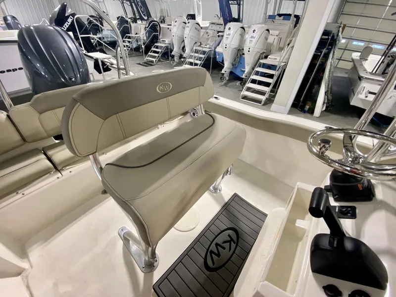 Slide: The Image of 2024 Key West 203 FS boat interior with seating and control console. - 8
