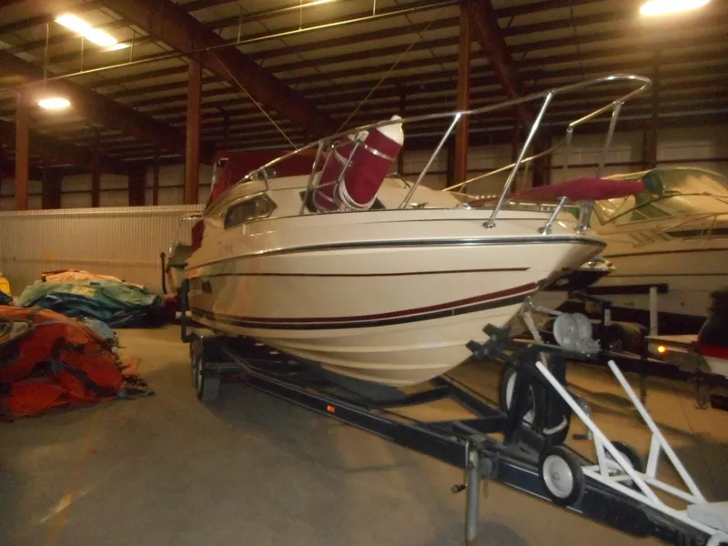 Slide: The Image of 1984 Beachcraft Cabin Cruiser in storage on a trailer. - 1
