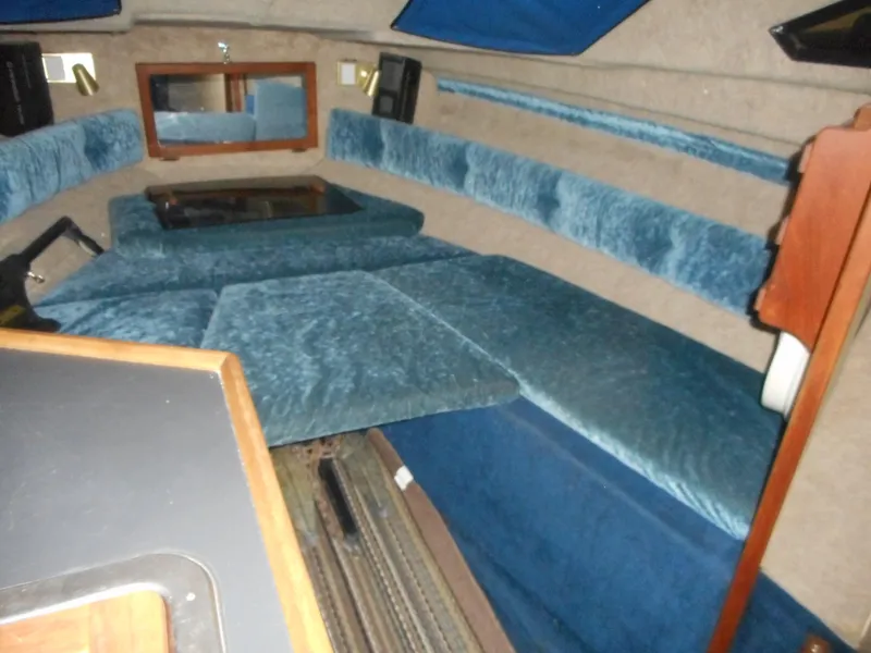 Slide: The Image of 1984 Beachcraft Cabin Cruiser interior with blue upholstery and wooden accents. - 15