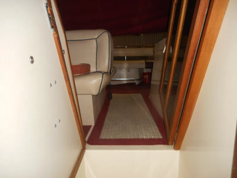 Slide: The Image of 1984 Beachcraft Cabin Cruiser interior with beige seating and red carpet. - 19