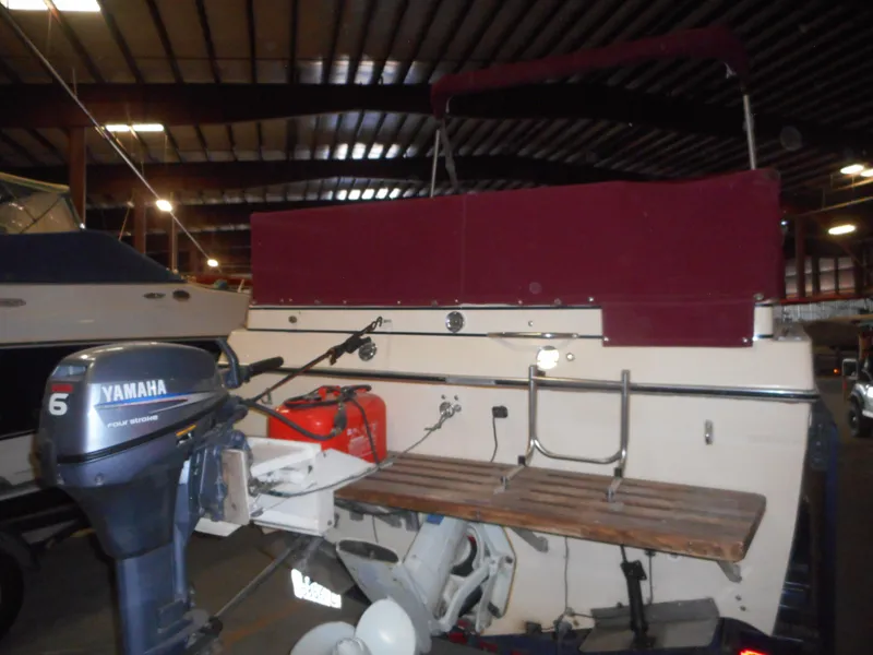 Slide: The Image of 1984 Beachcraft Cabin Cruiser with Yamaha outboard motor in storage facility. - 3