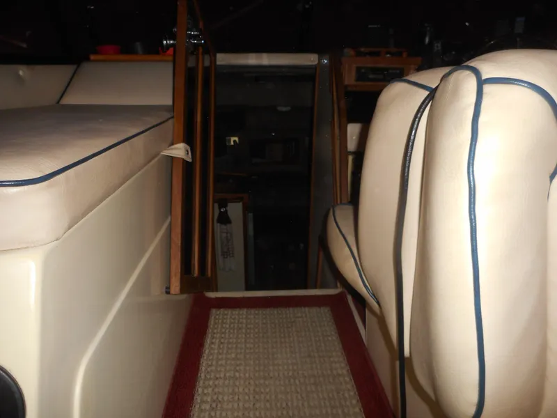Slide: The Image of Interior of a 1984 Beachcraft Cabin Cruiser with beige seating and red-trimmed carpet. - 9