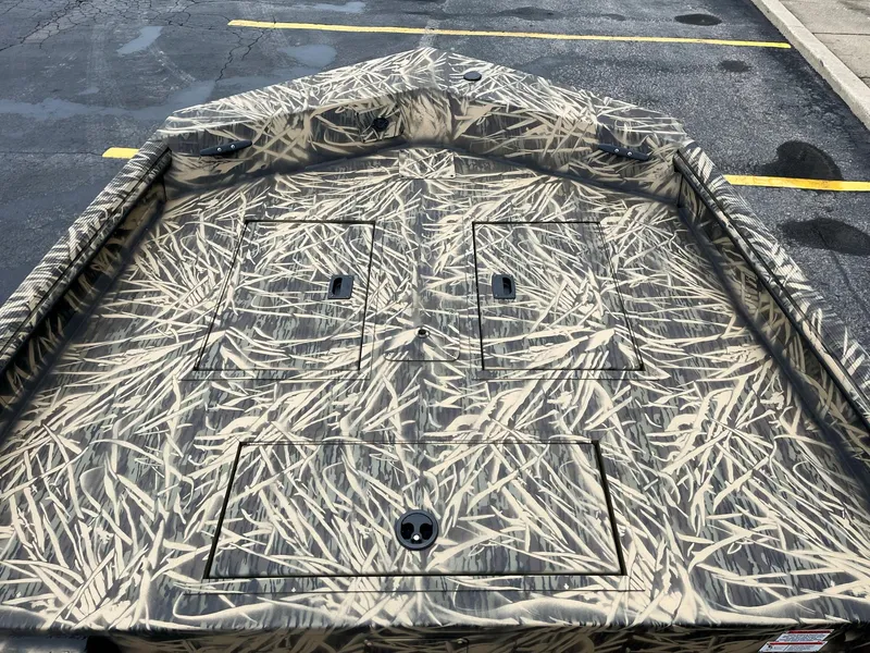 Slide: The Image of 2024 Lowe Roughneck RX1660 SC boat with camouflage interior design. - 11