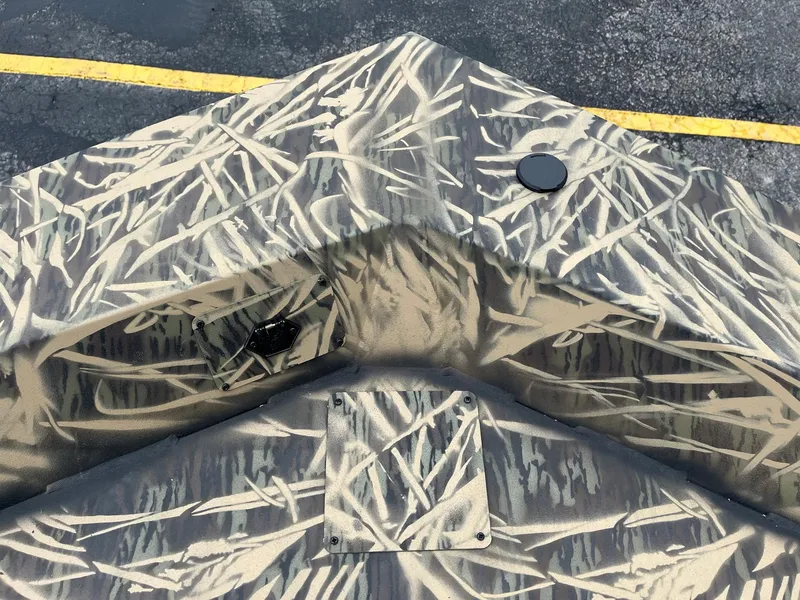 Slide: The Image of 2024 Lowe Roughneck RX1660 SC boat with camouflage pattern. - 13